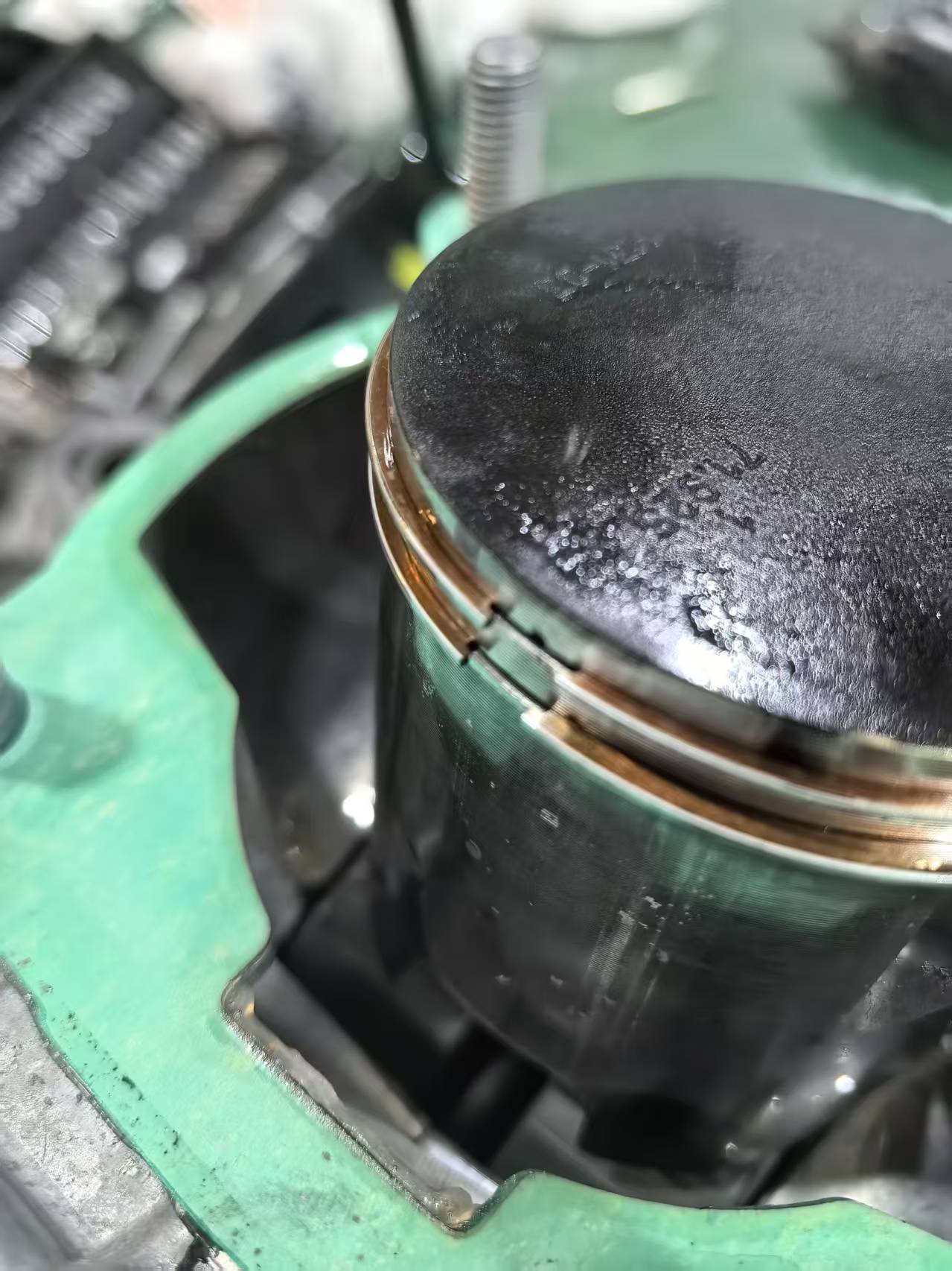 2-stroke piston locating pin close-up showing the pin position in the ring groove