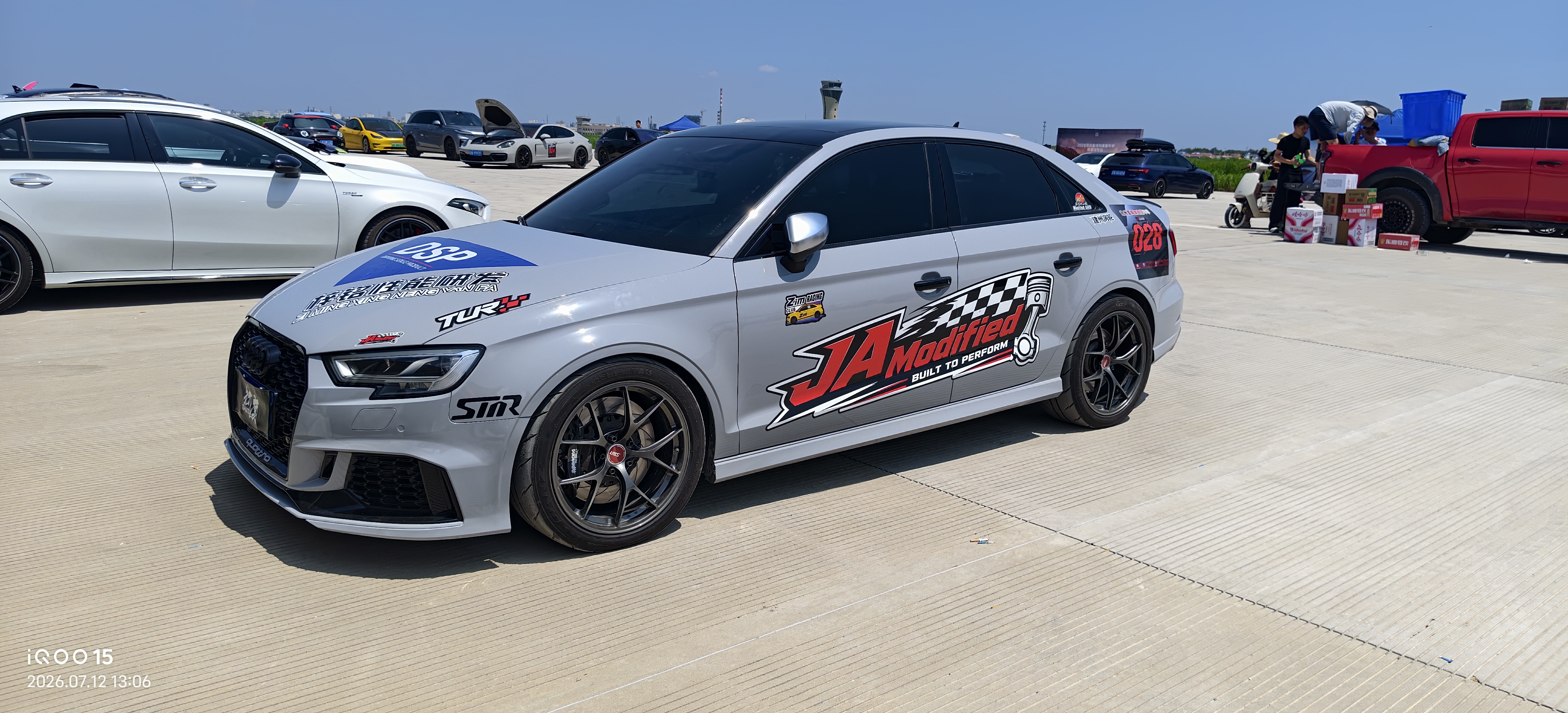 JA-Modified performance cars lined up at an automotive event